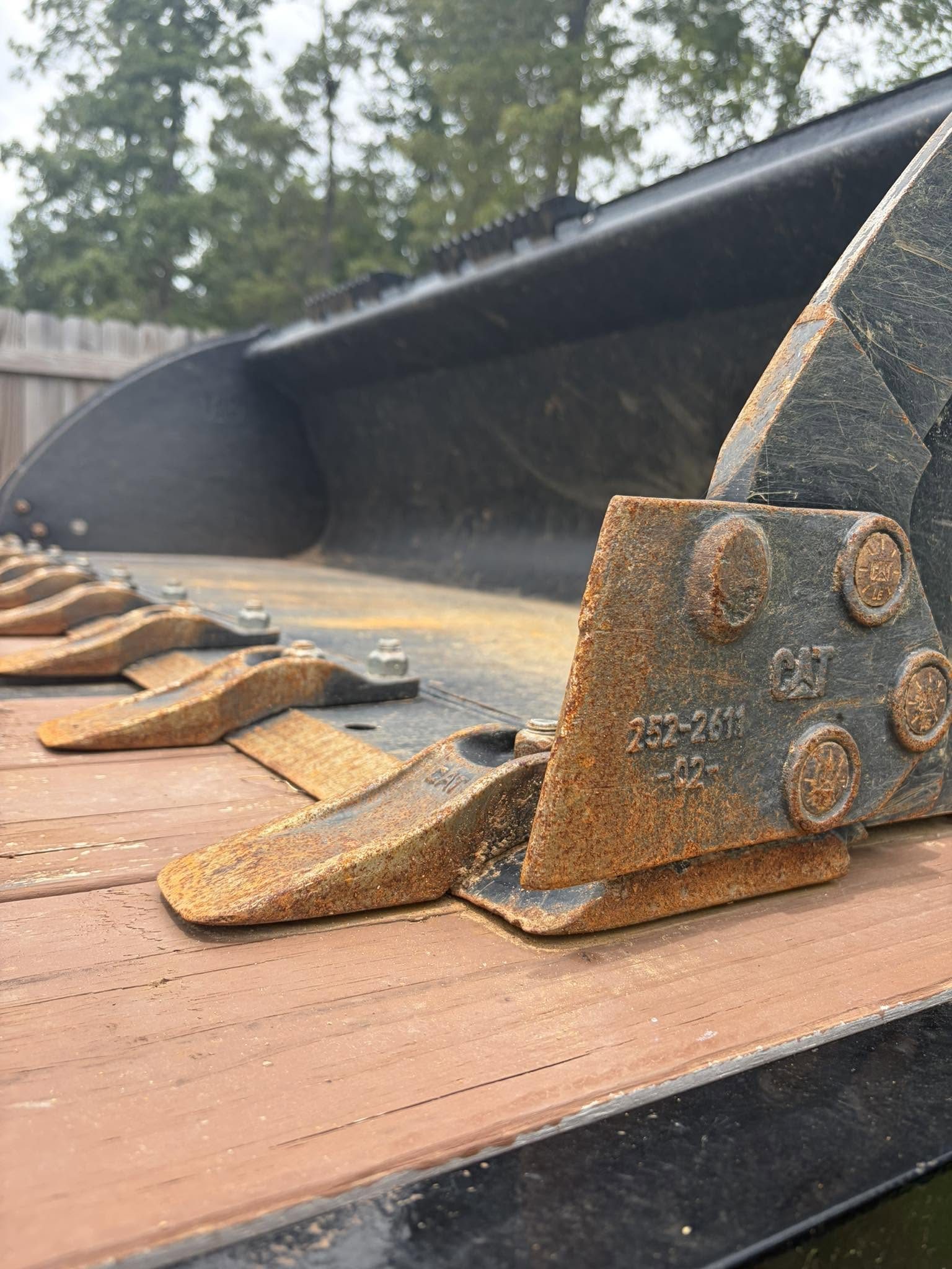 Close-up of a loader bucket grading red Georgia clay
