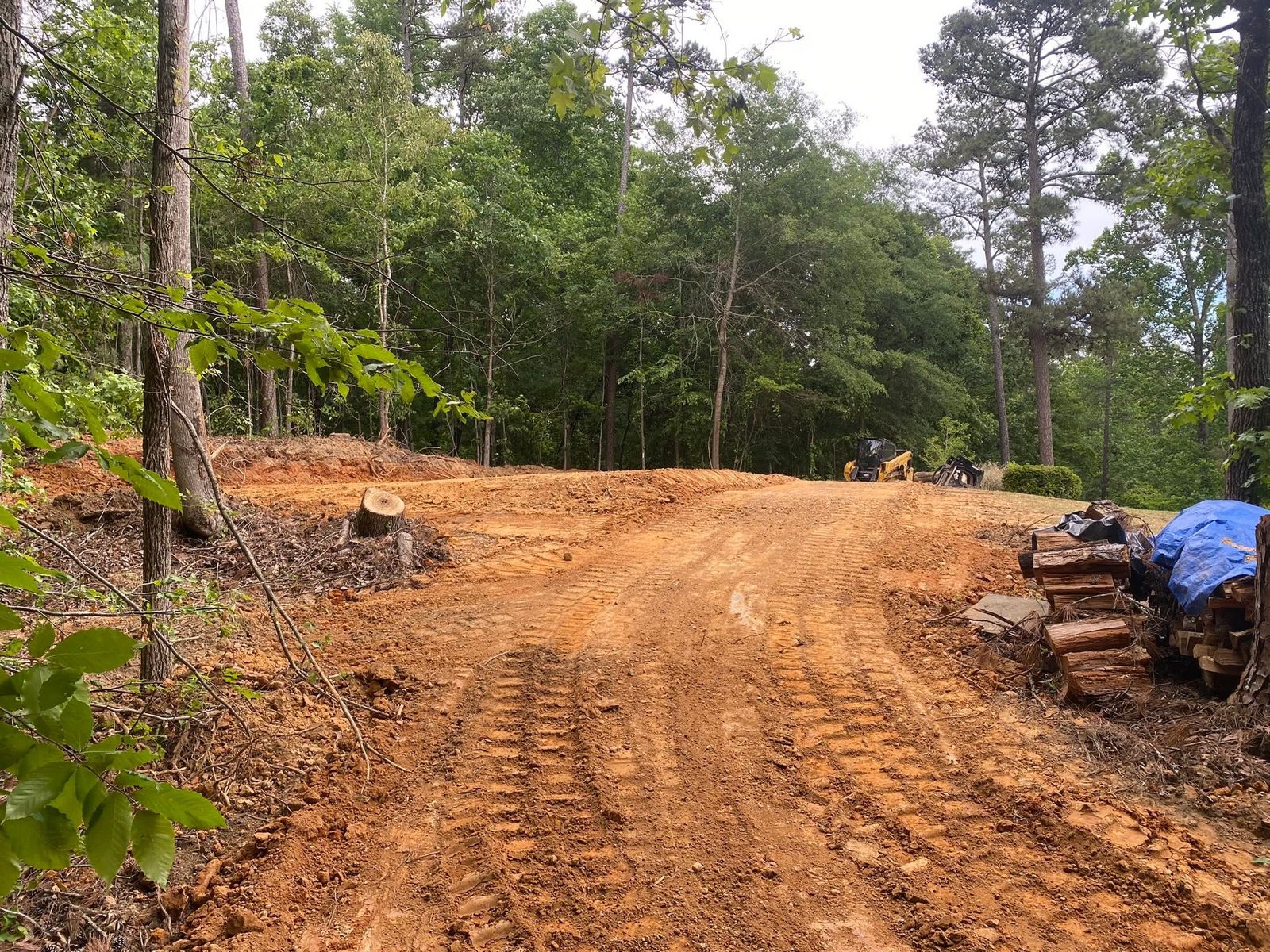 Excavator and dirt stockpile during site preparation work