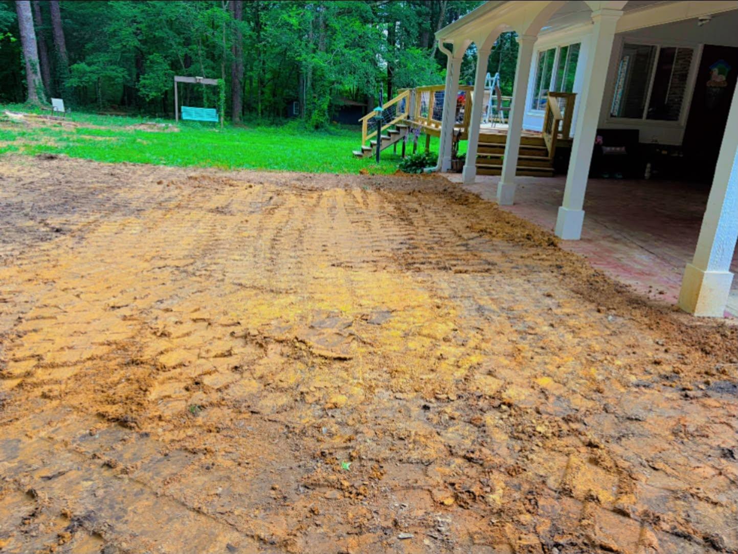 Finished driveway pad alongside a home