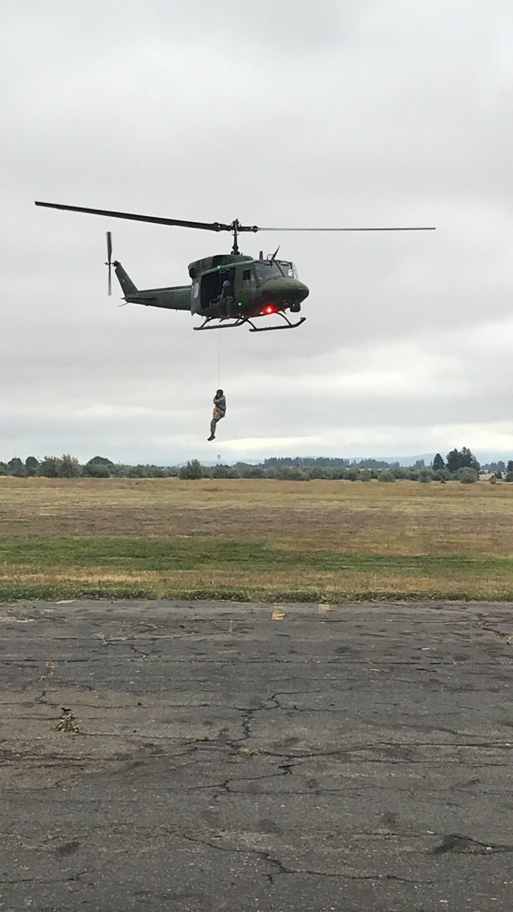 UH-1 Huey helicopter conducting hoist rescue training